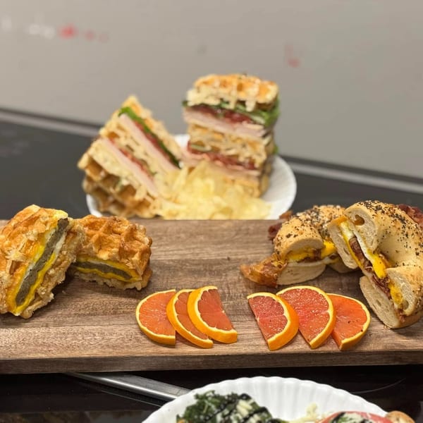Molli's Cafe!! breakfast spread with waffle sandwiches, bagel sandwiches, and grapefruit slices.
